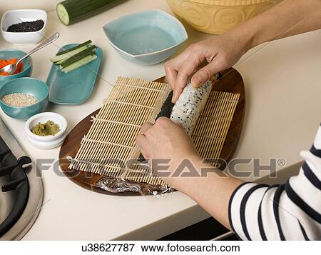 Woman rolling sushi at table View Large Photo Image Stock Photo - Woman rolling sushi at table. Fotosearch