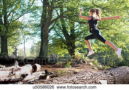 Stock Photograph - Woman running in park. Fotosearch