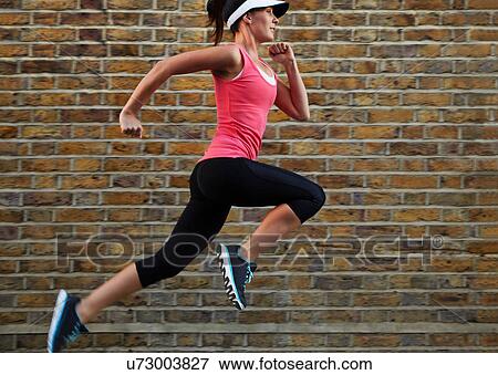Woman running on city street View Large Photo Image Stock Photo - Woman running on city street. Fotosearch