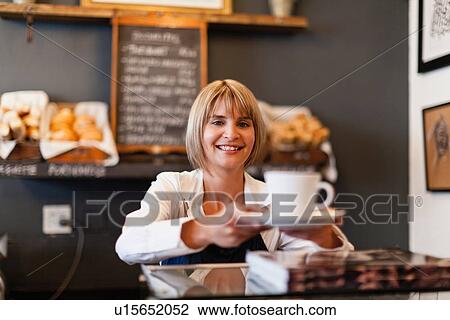 Woman serving coffee in cafe View Large Photo Image Stock Image - Woman serving coffee in cafe. Fotosearch