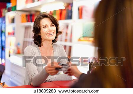 Woman shopping with credit card in store View Large Photo Image Stock Image - Woman shopping with credit card in store. Fotosearch