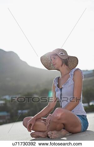 Woman sitting cross legged on beach View Large Photo Image Stock Image - Woman sitting cross legged on beach. Fotosearch