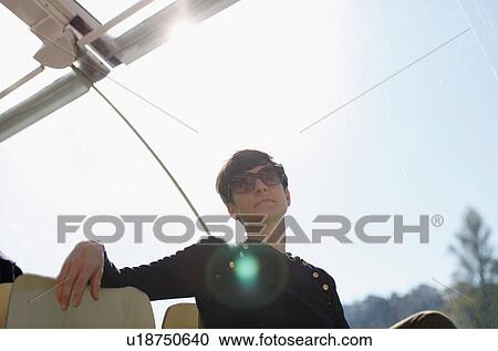 Woman sitting in boat outdoors View Large Photo Image Stock Image - Woman sitting in boat outdoors. Fotosearch