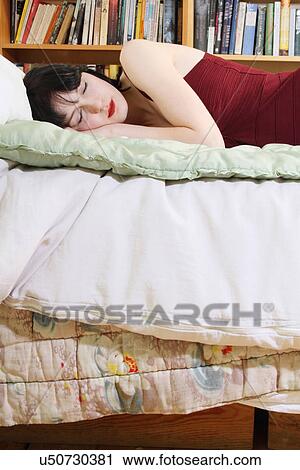 Woman sleeping on bed View Large Photo Image Stock Image - Woman sleeping on bed. Fotosearch