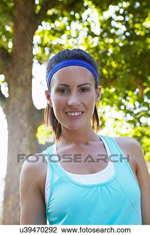 Stock Image - Woman smiling outdoors. Fotosearch