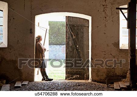 Woman standing at barn doors View Large Photo Image Stock Photo - Woman standing at barn doors. Fotosearch