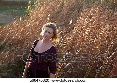 Woman standing in wheat field View Large Photo Image Stock Image - Woman standing in wheat field. Fotosearch