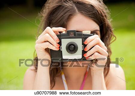Woman taking pictures in park View Large Photo Image Stock Photo - Woman taking pictures in park. Fotosearch