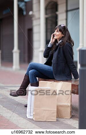 Woman talking on cell phone and shopping View Large Photo Image Stock Image - Woman talking on cell phone and shopping. Fotosearch