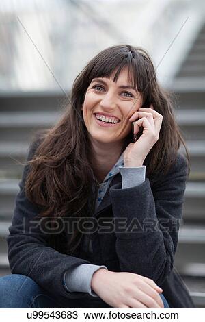 Stock Image - Woman talking on cell phone. Fotosearch