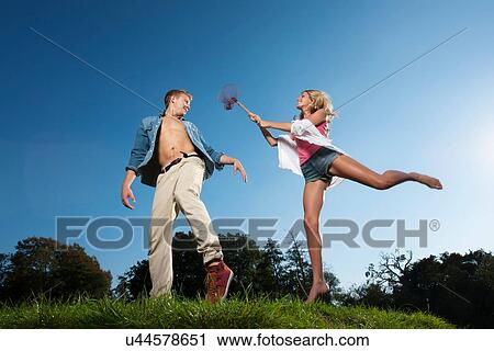 Woman using butterfly net on boyfriend View Large Photo Image Stock Image - Woman using butterfly net on boyfriend. Fotosearch