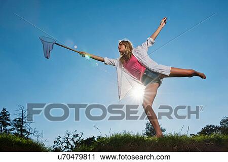Woman using butterfly net outdoors View Large Photo Image Stock Image - Woman using butterfly net outdoors. Fotosearch
