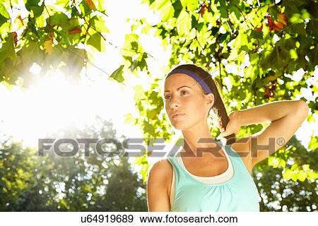Stock Photo - Woman walking in park. Fotosearch