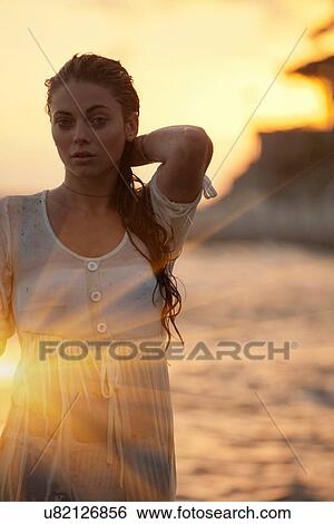 Woman walking in water at beach View Large Photo Image Stock Photograph - Woman walking in water at beach. Fotosearch