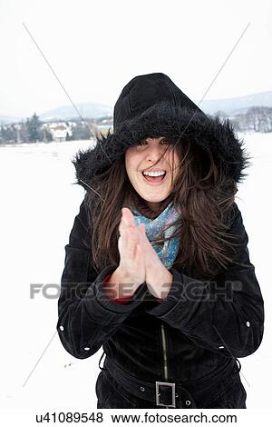 Stock Photo - Woman wearing parka in snow. Fotosearch