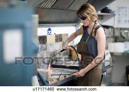 Woman wearing safety goggles using blowtorch for metalworking View Large Photo Image Stock Image - Woman wearing safety goggles using blowtorch for metalworking. Fotosearch