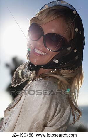 Stock Photo - Woman wearing scarf on her head. Fotosearch