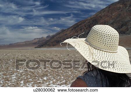 Woman wearing sunhat on rural road View Large Photo Image Stock Image - Woman wearing sunhat on rural road. Fotosearch