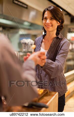 Woman with free samples in grocery store View Large Photo Image Stock Image - Woman with free samples in grocery store. Fotosearch