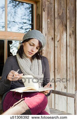 Woman writing in notebook on porch View Large Photo Image Stock Image - Woman writing in notebook on porch. Fotosearch