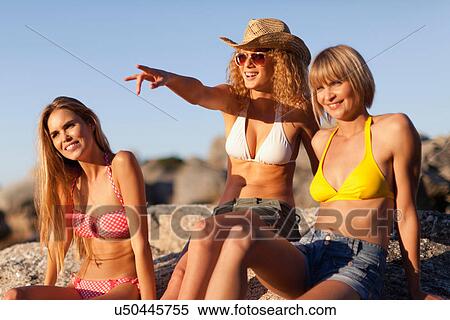 Stock Photography - Women admiring beach together. Fotosearch