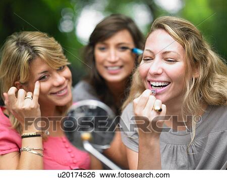 Women applying makeup in car mirror View Large Photo Image Stock Photograph - Women applying makeup in car mirror. Fotosearch