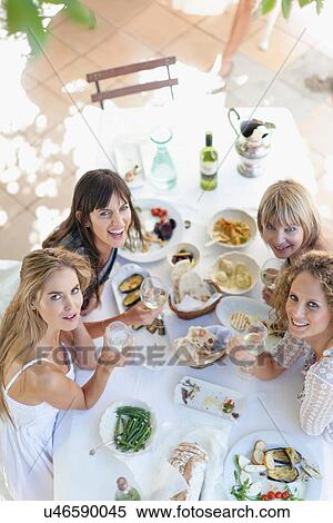 Women eating at table outdoors View Large Photo Image Stock Photography - Women eating at table outdoors. Fotosearch