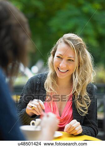Picture - Women having coffee at sidewalk cafe. Fotosearch