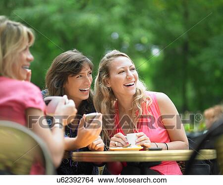 Women having coffee at sidewalk cafe View Large Photo Image Picture - Women having coffee at sidewalk cafe. Fotosearch
