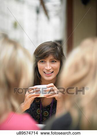 Women having coffee at sidewalk cafe View Large Photo Image Picture - Women having coffee at sidewalk cafe. Fotosearch