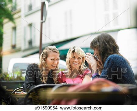 Picture - Women having coffee at sidewalk cafe. Fotosearch
