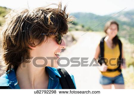 Stock Photo - Women hiking together on hill. Fotosearch
