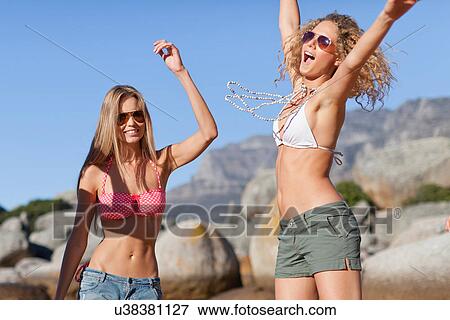 Women in bikinis playing on beach View Large Photo Image Stock Photo - Women in bikinis playing on beach. Fotosearch