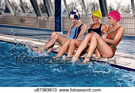 Stock Image - Women playing in indoor pool. Fotosearch