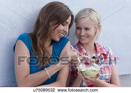 Women sharing salad outdoors View Large Photo Image Stock Image - Women sharing salad outdoors. Fotosearch