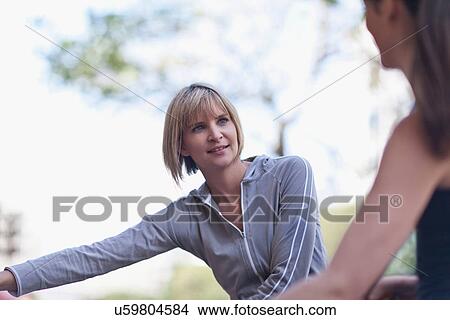Picture - Women stretching before workout outdoors. Fotosearch
