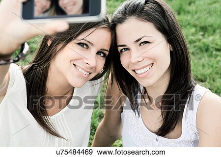 Women taking a picture of themselves View Large Photo Image Stock Photo - Women taking a picture of themselves. Fotosearch