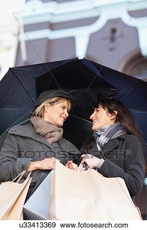 Women under umbrellas on city street View Large Photo Image Stock Photo - Women under umbrellas on city street. Fotosearch