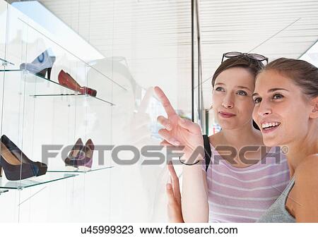 Women window shopping together View Large Photo Image Stock Image - Women window shopping together. Fotosearch