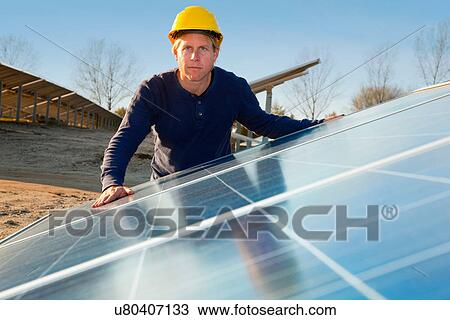 Worker examining solar panels View Large Photo Image Stock Image - Worker examining solar panels. Fotosearch