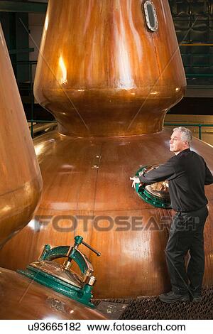 Worker in whisky distillery View Large Photo Image Stock Image - Worker in whisky distillery. Fotosearch