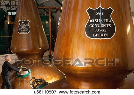 Worker in whisky distillery View Large Photo Image Stock Photo - Worker in whisky distillery. Fotosearch