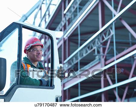 Workman by van and steel construction frame on building site View Large Photo Image Stock Photo - Workman by van and steel construction frame on building site. Fotosearch