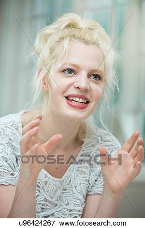 Young woman in conversation View Large Photo Image Stock Photo - Young woman in conversation. Fotosearch