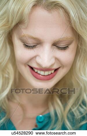 Stock Image - Young woman with eyes closed. Fotosearch