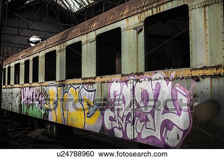 "Abandoned train carriage and graffiti in railway shed, Inota, Hungary" View Large Photo Image Stock Image - "Abandoned train carriage and graffiti in railway shed, Inota, Hungary". Fotosearch