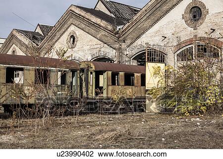 Stock Image - "Abandoned train carriages and railway shed, Inota, Hungary". Fotosearch