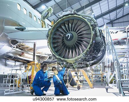 Aircraft engineers inspecting jet engine in aircraft maintenance factory View Large Photo Image Stock Photo - Aircraft engineers inspecting jet engine in aircraft maintenance factory. Fotosearch