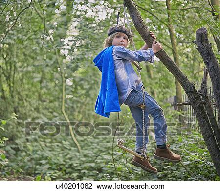 Boy dressed up and playing in forest tree View Large Photo Image Stock Image - Boy dressed up and playing in forest tree. Fotosearch