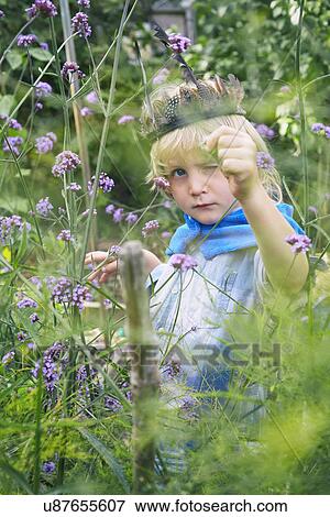 Boy dressed up and playing with plants in garden View Large Photo Image Stock Photo - Boy dressed up and playing with plants in garden. Fotosearch